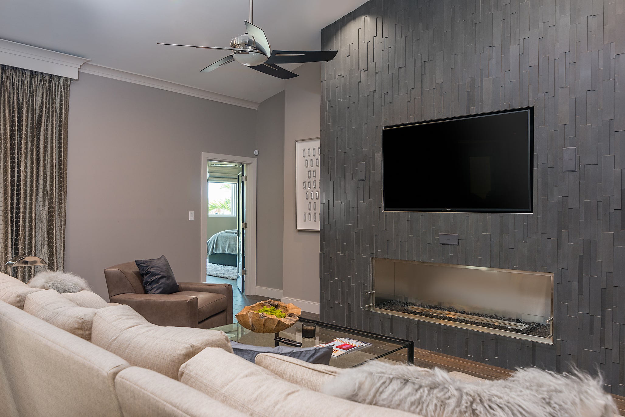Norstone Grey Aksent stone veneer used vertically with a modern gas fireplace with no hearth